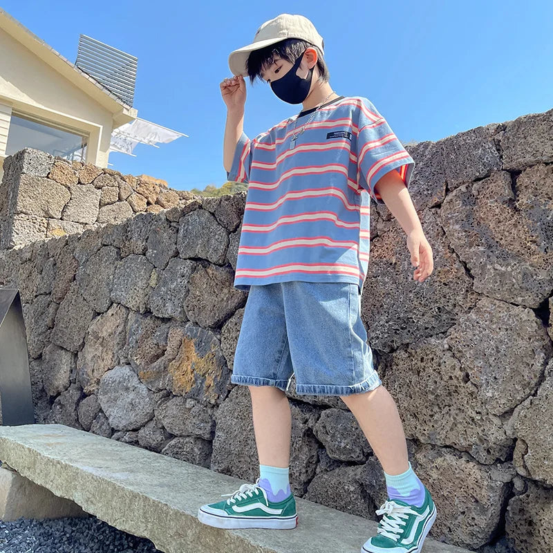 tween boy wearing stripe t shirt and denim shorts
