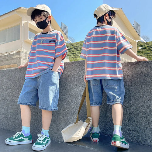 tween boy wearing stripe t shirt and denim shorts
